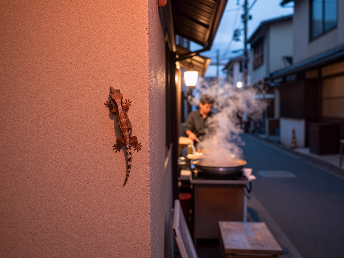 Osaka Japan street scene copper dusk light gecko wall and food stall in in Osaka, Japan
