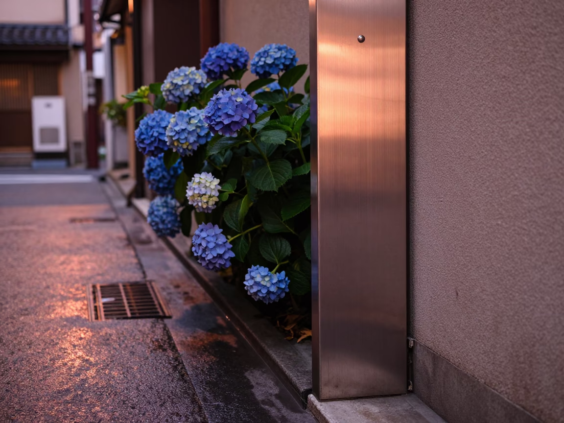 Osaka Japan street scene with brushed steel doorframe and hydrangeas in copper dusk light in in Osaka, Japan