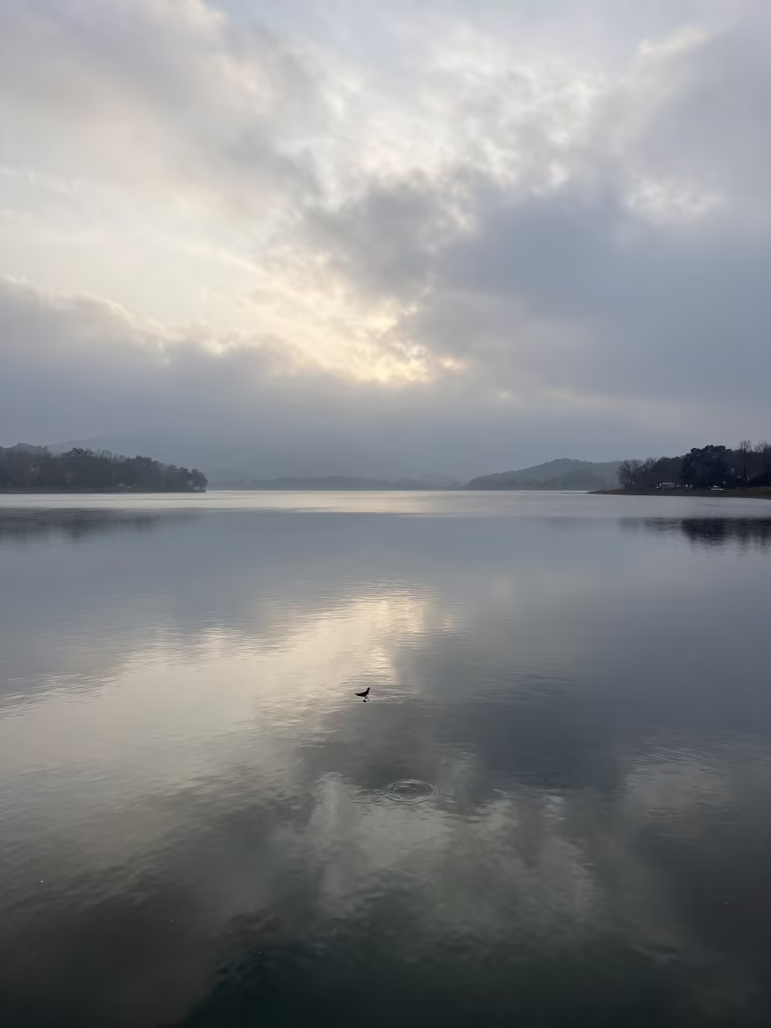 Overcast Lake Sky Before Sunrise with Snow in through low marine fog in Hubei