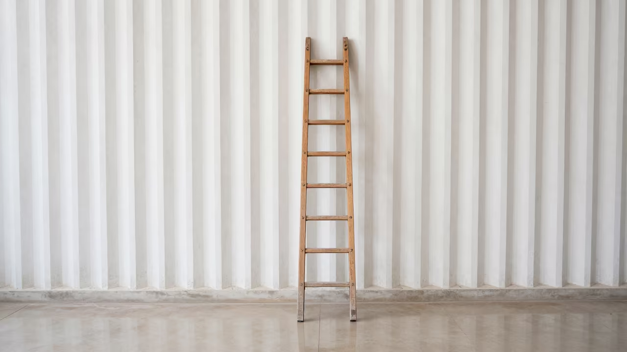 Overhead Ladder on Whitewashed Ribbed Concrete Wall in inside a ribbed concrete lobby near Batna