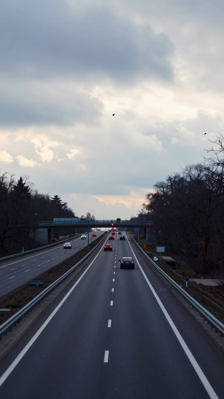 Overpass Lane Split Taillight Streaks Before Sunrise in along a dam spillway in Ukraine