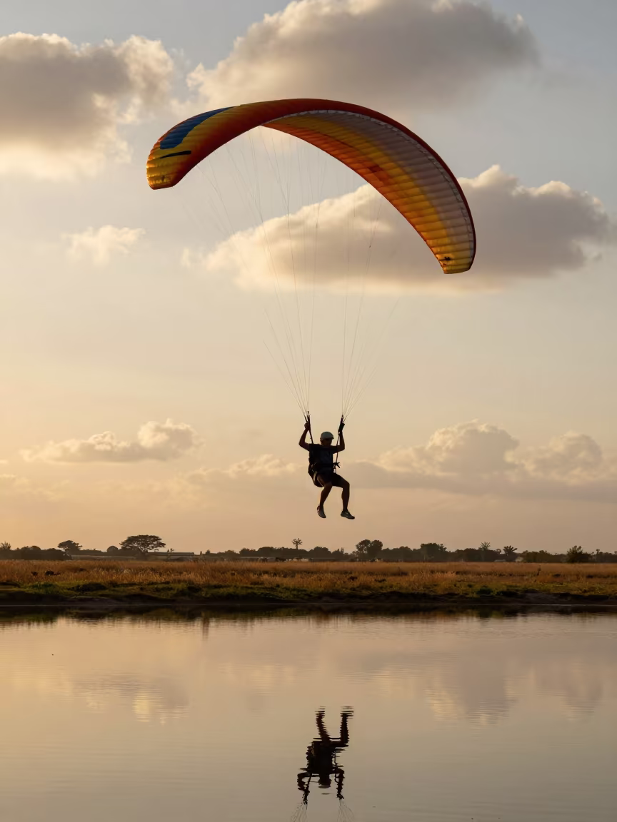 Paraglider Full Stall Over Calm Lake in near open fields near Touba