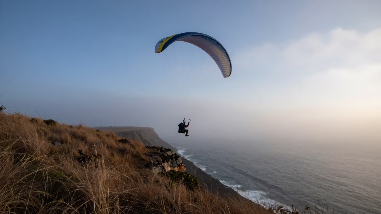 Paraglider Launches Through Sharp Fog Edge at Dawn in near open fields near Salvador