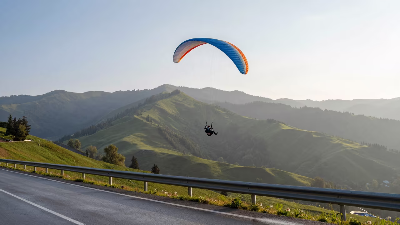 Paraglider Soaring Over Green Valley Near Almaty in at a roadside stop near Almaty