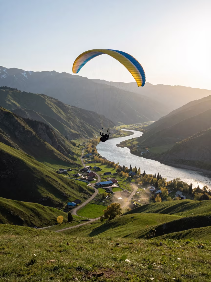 Paraglider Soaring Over Green Almaty Valley in in a village lane near Almaty