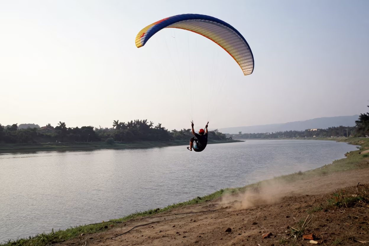 Paraglider Stall Above Taipei Lake at Dawn in by a riverbank near Taipei