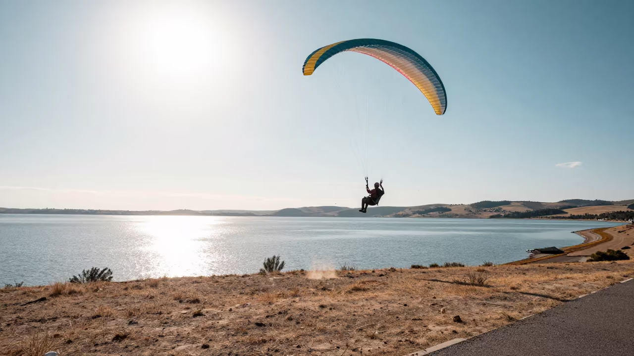 Paraglider Stalls Above Calm Lake in Midmorning in at a roadside stop near Burao