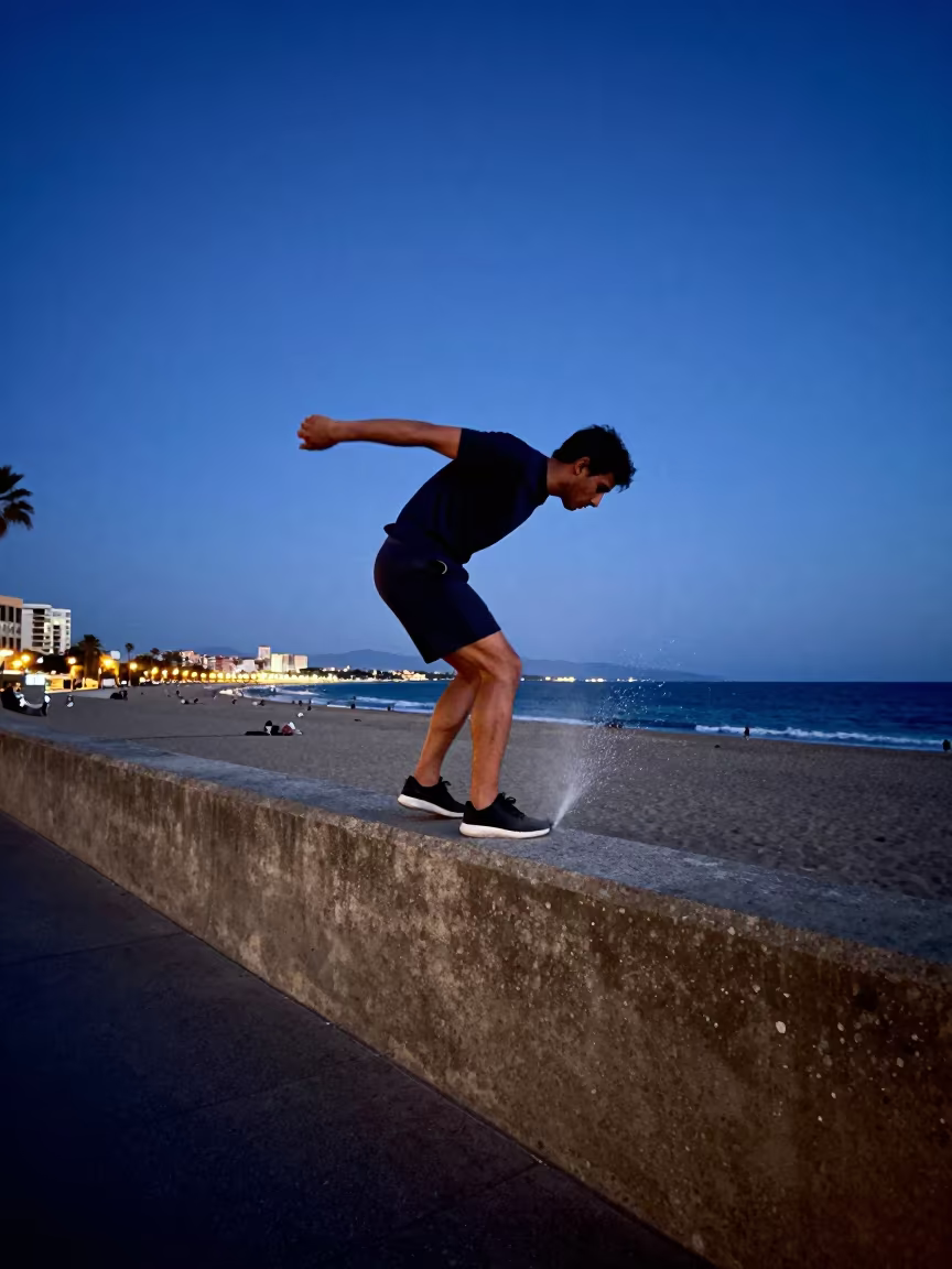 Parkour Runner Balancing on Beach Parapet at Twilight in along a beach near Madrid