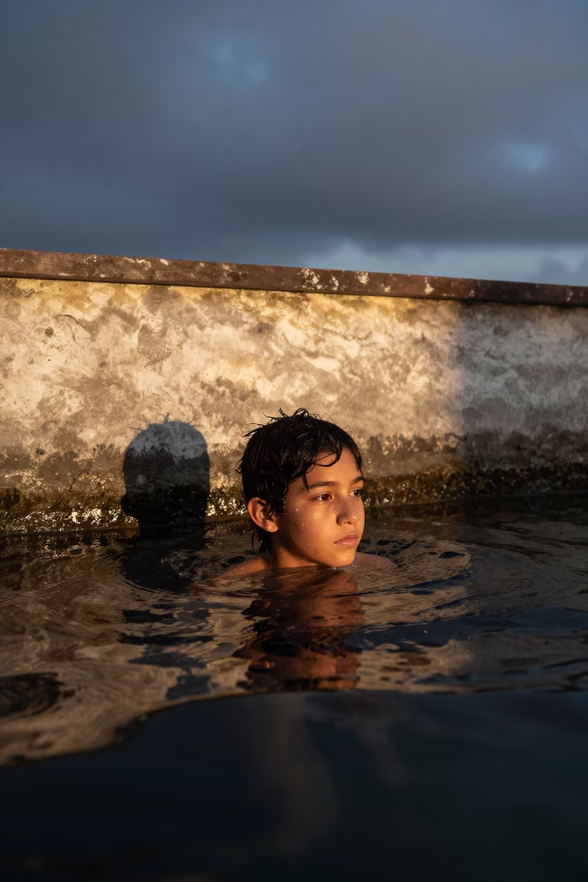Pearl Diver Surfacing Twilight Mwanza in against a sun-bleached plaster wall near Mwanza