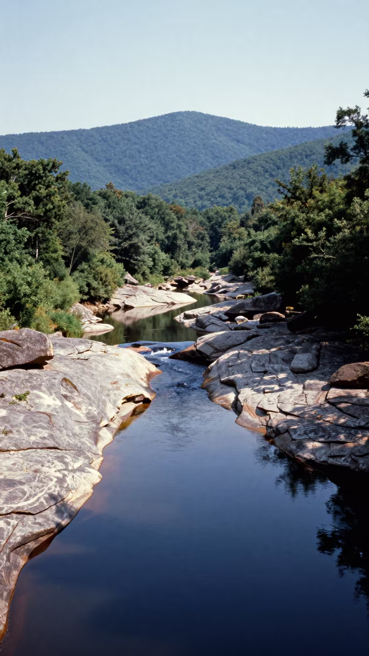 Peat River Flows Over Granite Virginia Foothills in from a ridge above layered foothills in Virginia