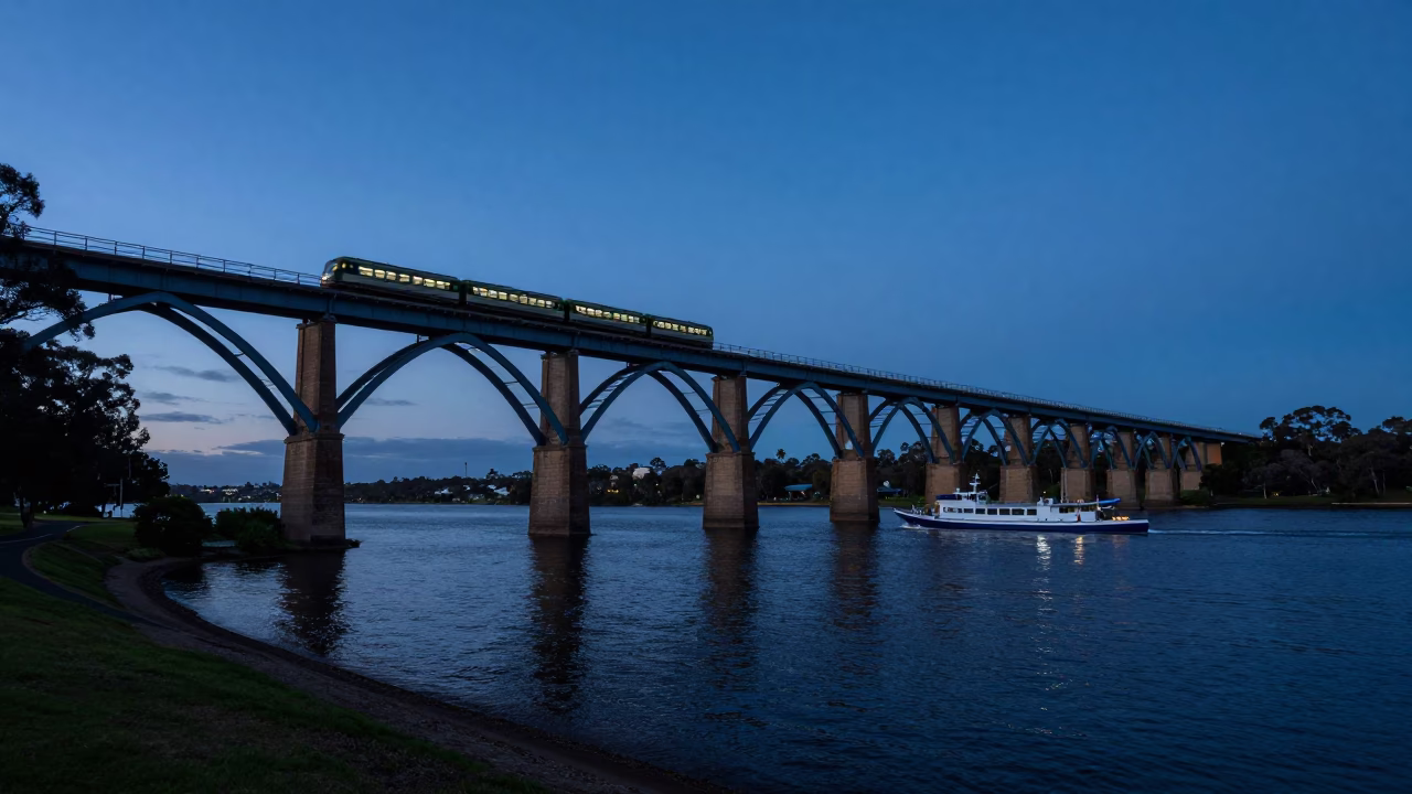 Perth Western Australia Blue Hour Railway Viaduct with Passing Train and Longtail Boat in in Perth, Western Australia, Australia