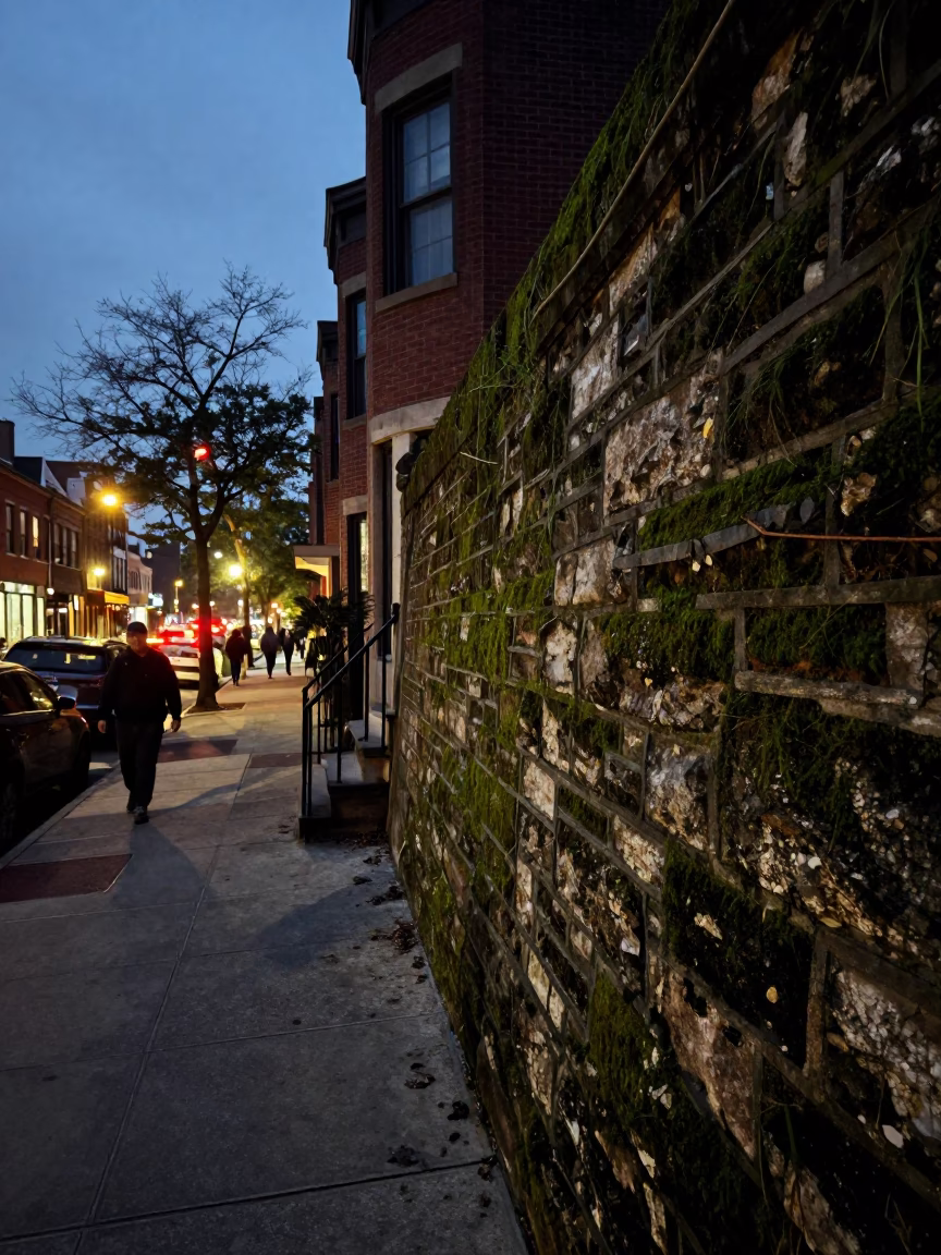 Philadelphia Street Scene at Dusk with Mossy Stone Wall and City Lights Glowing in in Philadelphia, Pennsylvania, United States