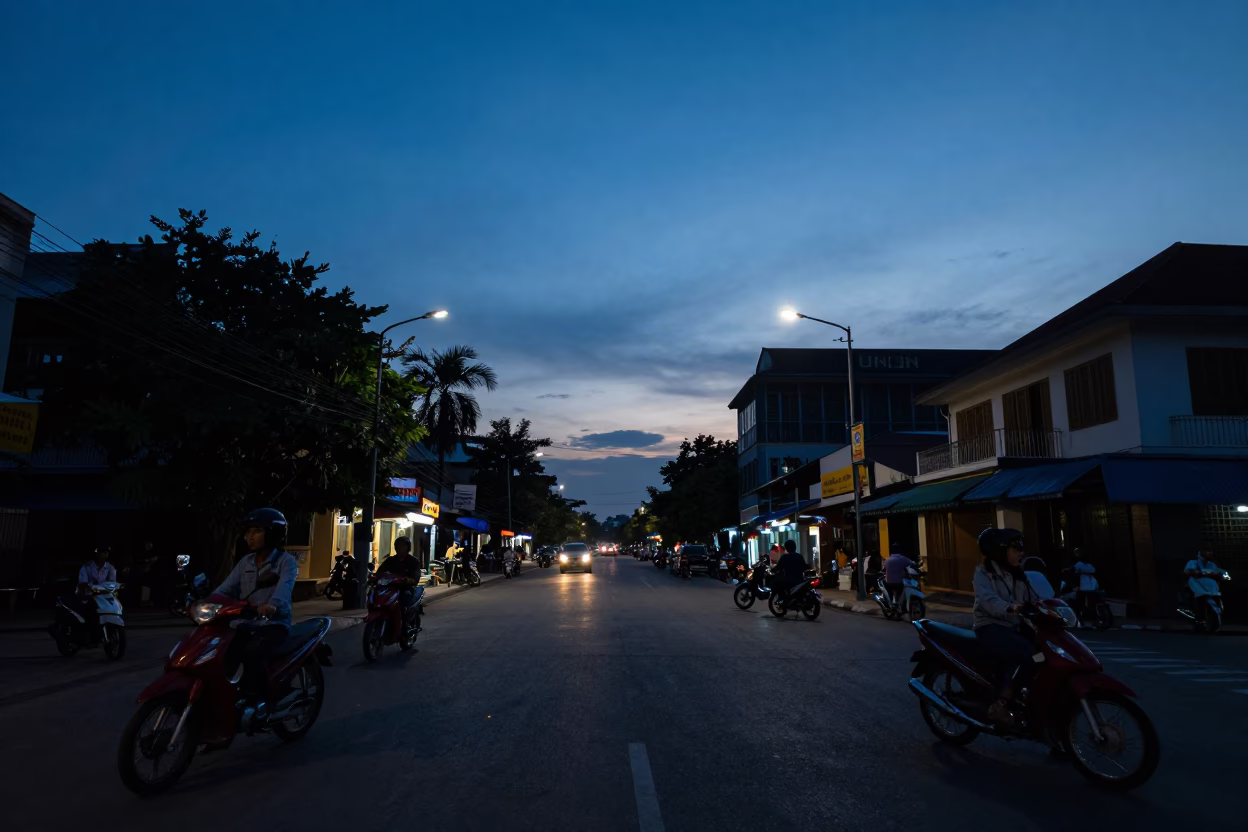 Phnom Penh Cambodia indigo twilight street scene with motorbikes and local vendors in in Phnom Penh, Cambodia