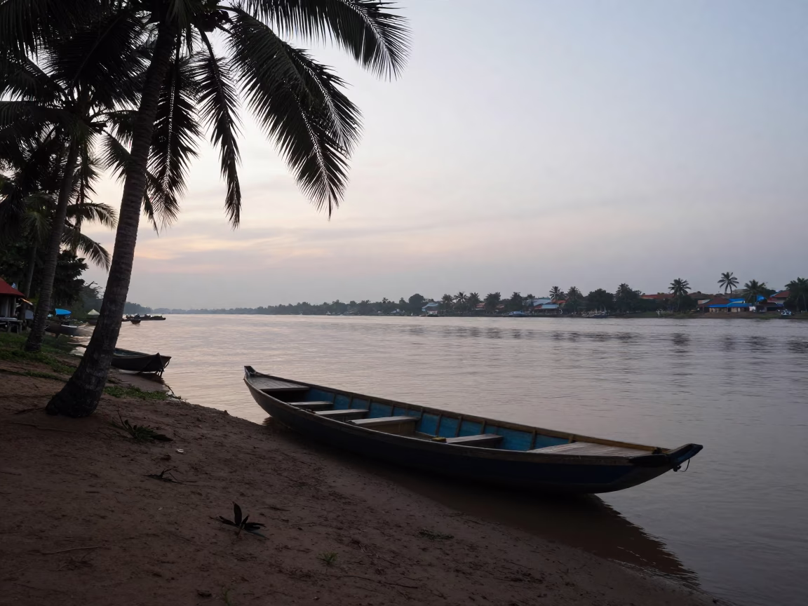 Phnom Penh Pre-Dawn River Scene with Date Palms and Moored Boat in in Phnom Penh, Cambodia