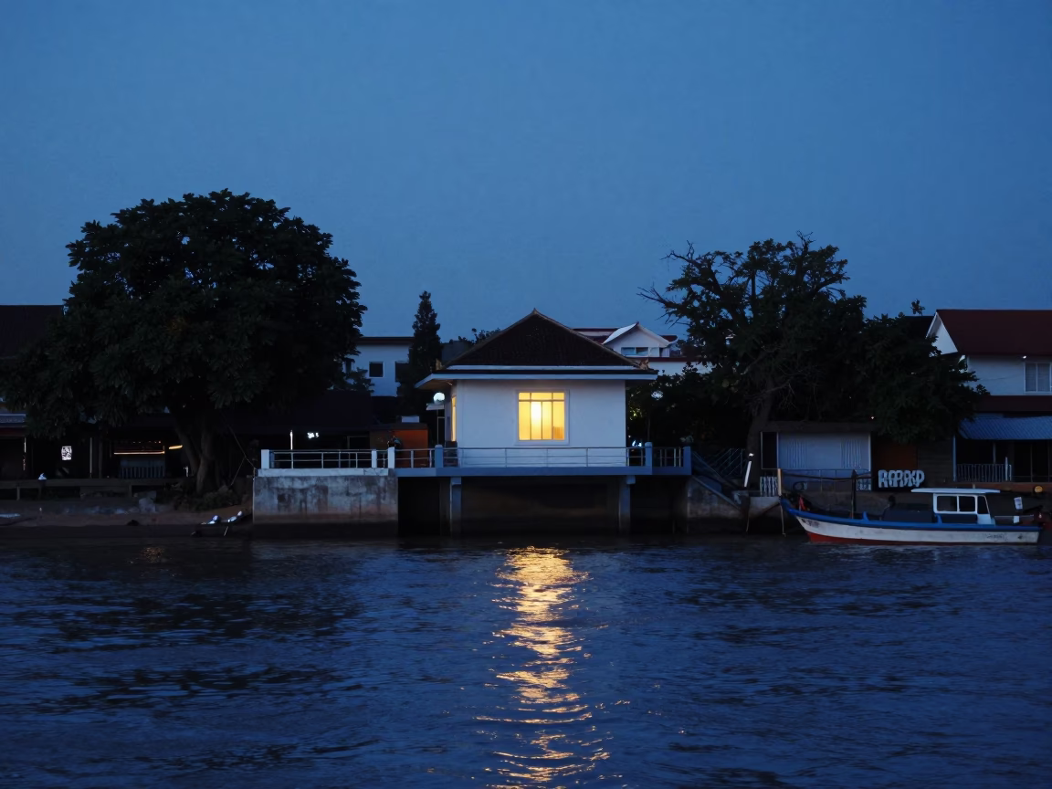 Phnom Penh Twilight Street Scene with Glowing Pump House Window Over Floodwater in in Phnom Penh, Cambodia