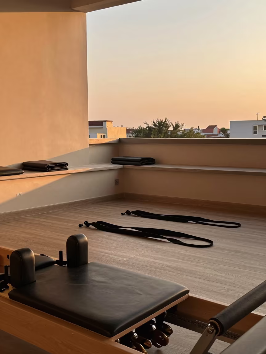 Pilates Reformer Studio Evening Light Delhi in inside a reformer studio with straps laid straight in Delhi