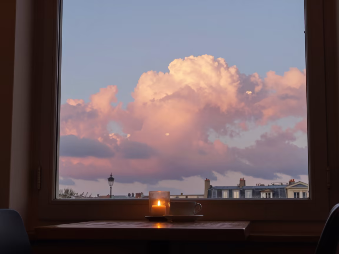 Pink Clouds Over Paris Cafe Table in on a cafe table by a window near Paris