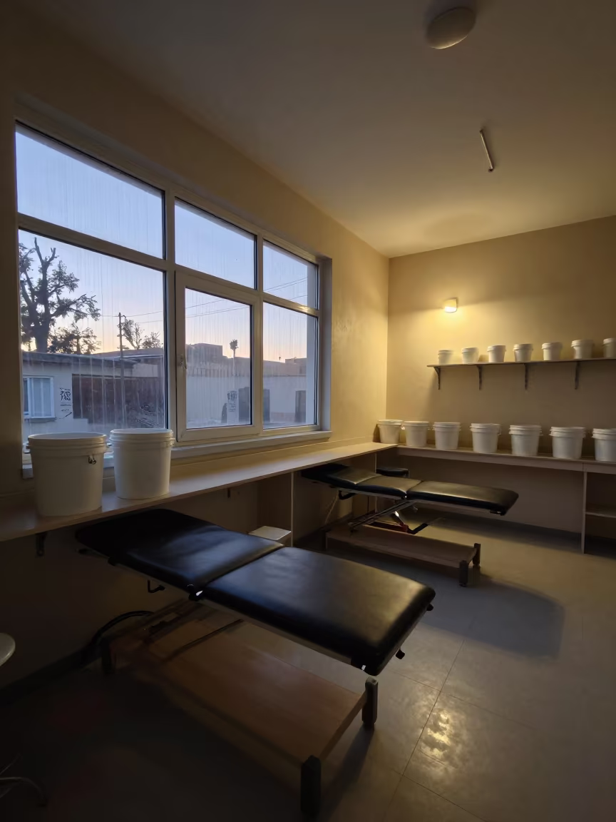 Plaster Bucket Shelf in Kafr Clinic Twilight in inside a clinic exam room in Kafr el-Sheikh
