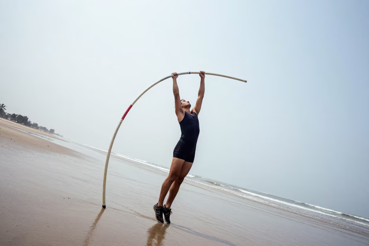 Pole Vaulter Bends Pole on Beach at Noon in along a beach near Dera Ghazi Khan