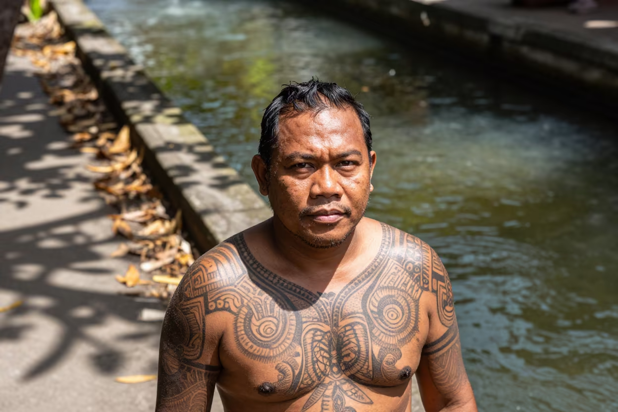 Polynesian Chief with Full Face Tattoo Beside Canal in beside a canal in Denpasar