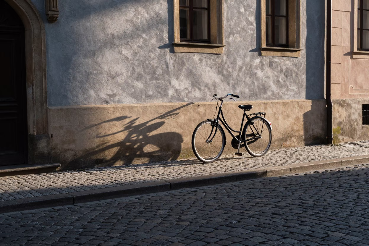Prague Morning Light Illuminating Cobblestone Street and Vintage Bicycle Near Charles Bridge in in Prague, Czech Republic