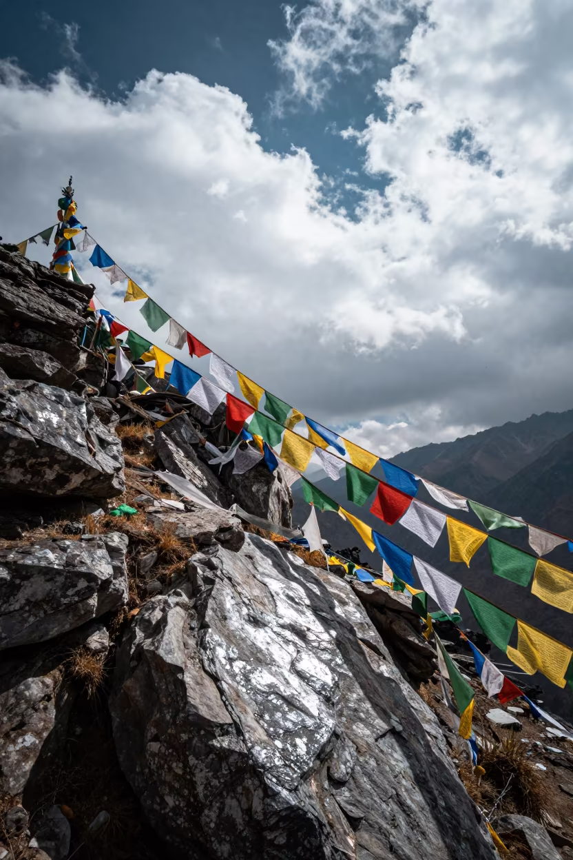 Prayer Flags Snapping in Wind Over Kathmandu Valley in at a rocky saddle overlooking a mountain valley near Kathmandu
