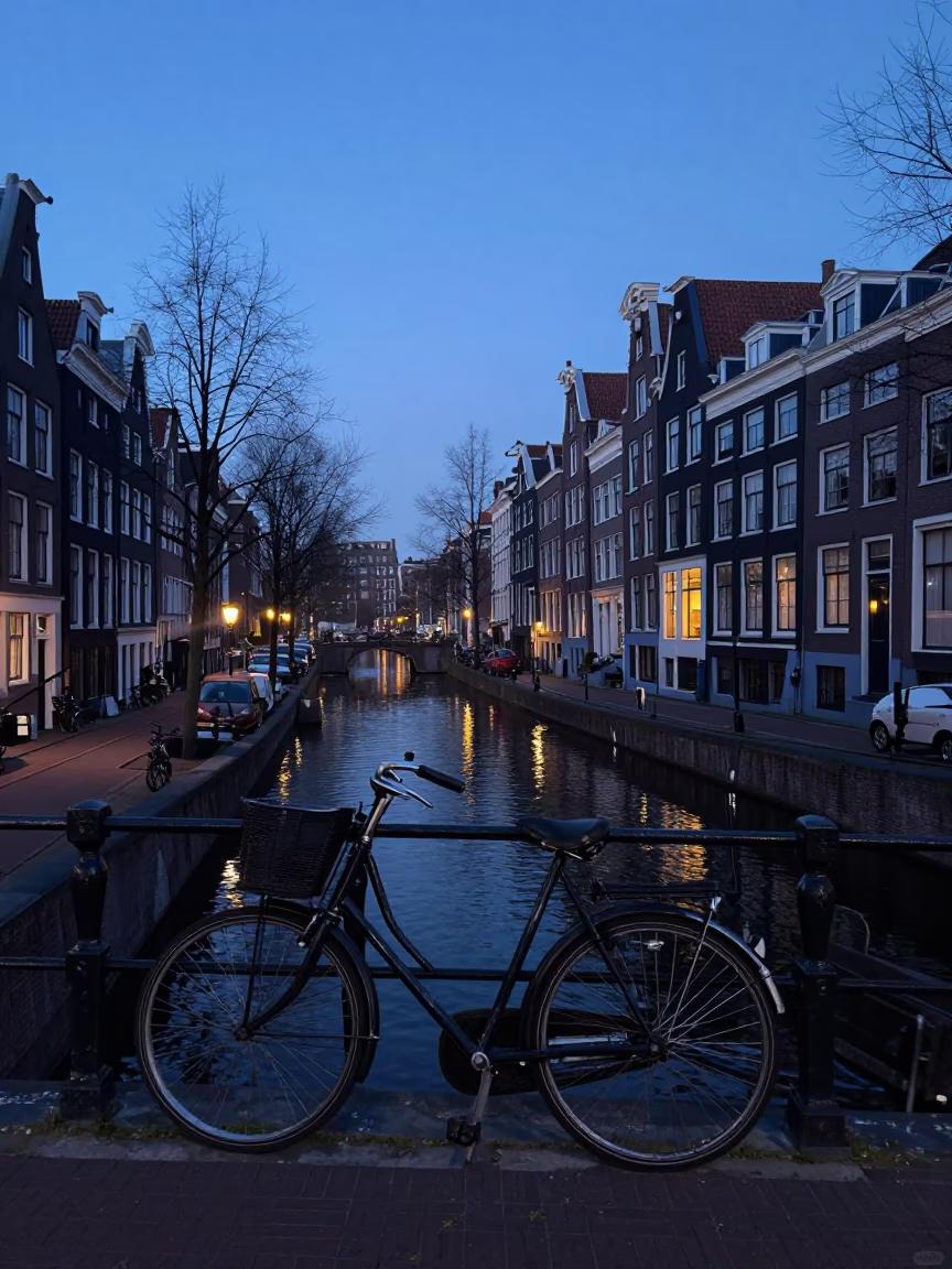Pre-dawn Amsterdam Canal Street with Vintage Bicycle and Morning Mist in in Amsterdam, Netherlands