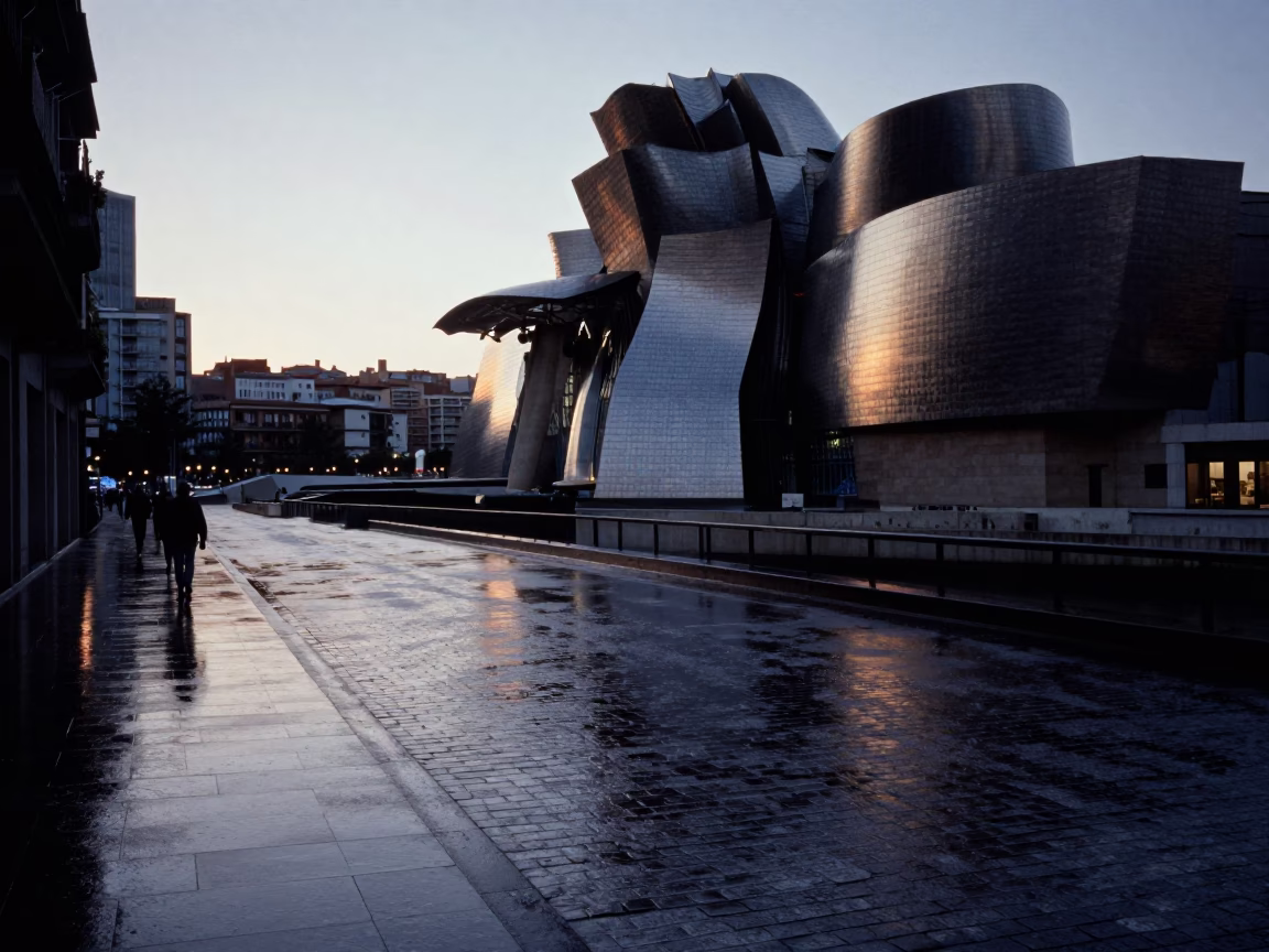 Pre-dawn Bilbao street scene with wet pavement and distant bridge lights in in Bilbao, Spain