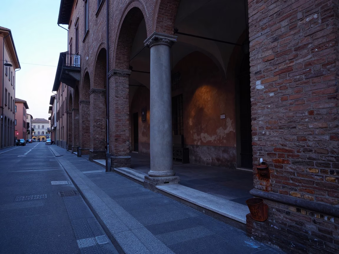 Pre-dawn Bologna street scene with rusted cup and step ladder near historic portico in in Bologna, Italy