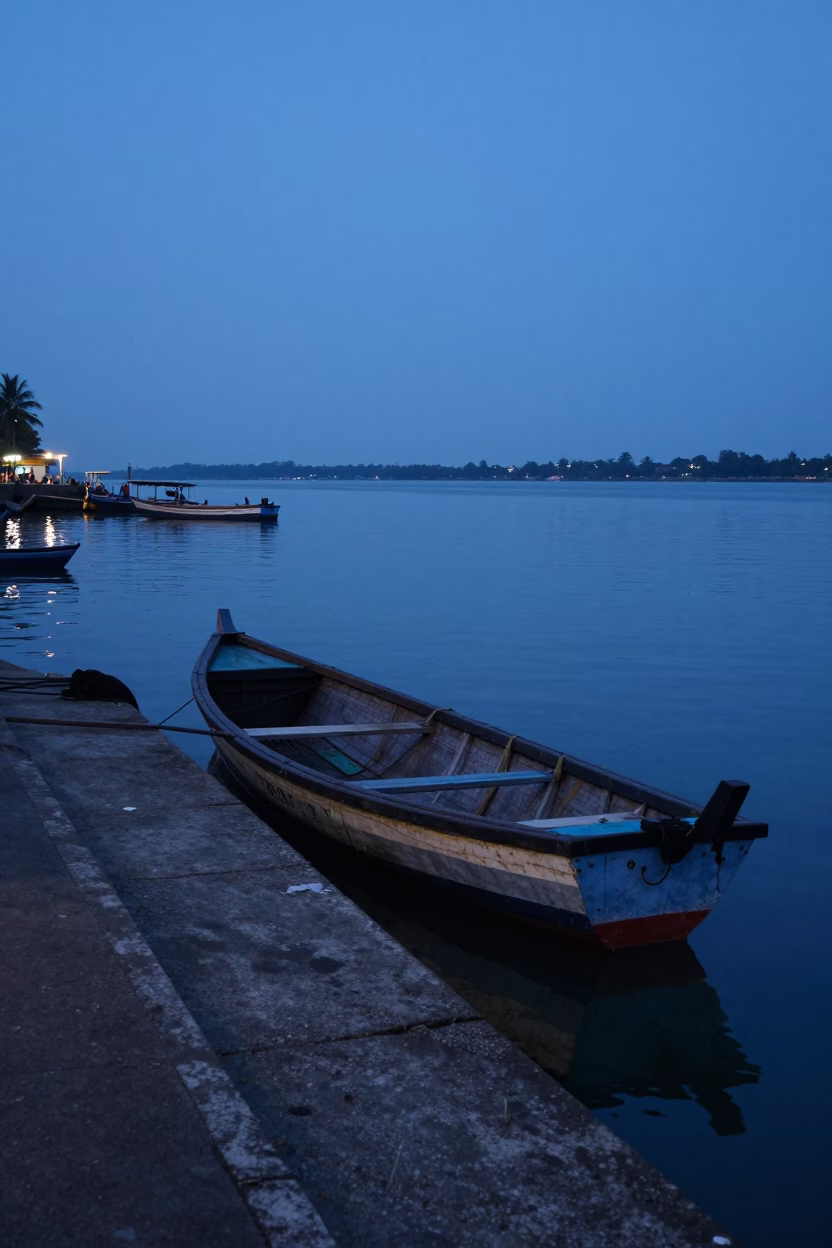 Pre-dawn fishing harbor scene with rowing boat and activity in Kochi India in in Kochi, India