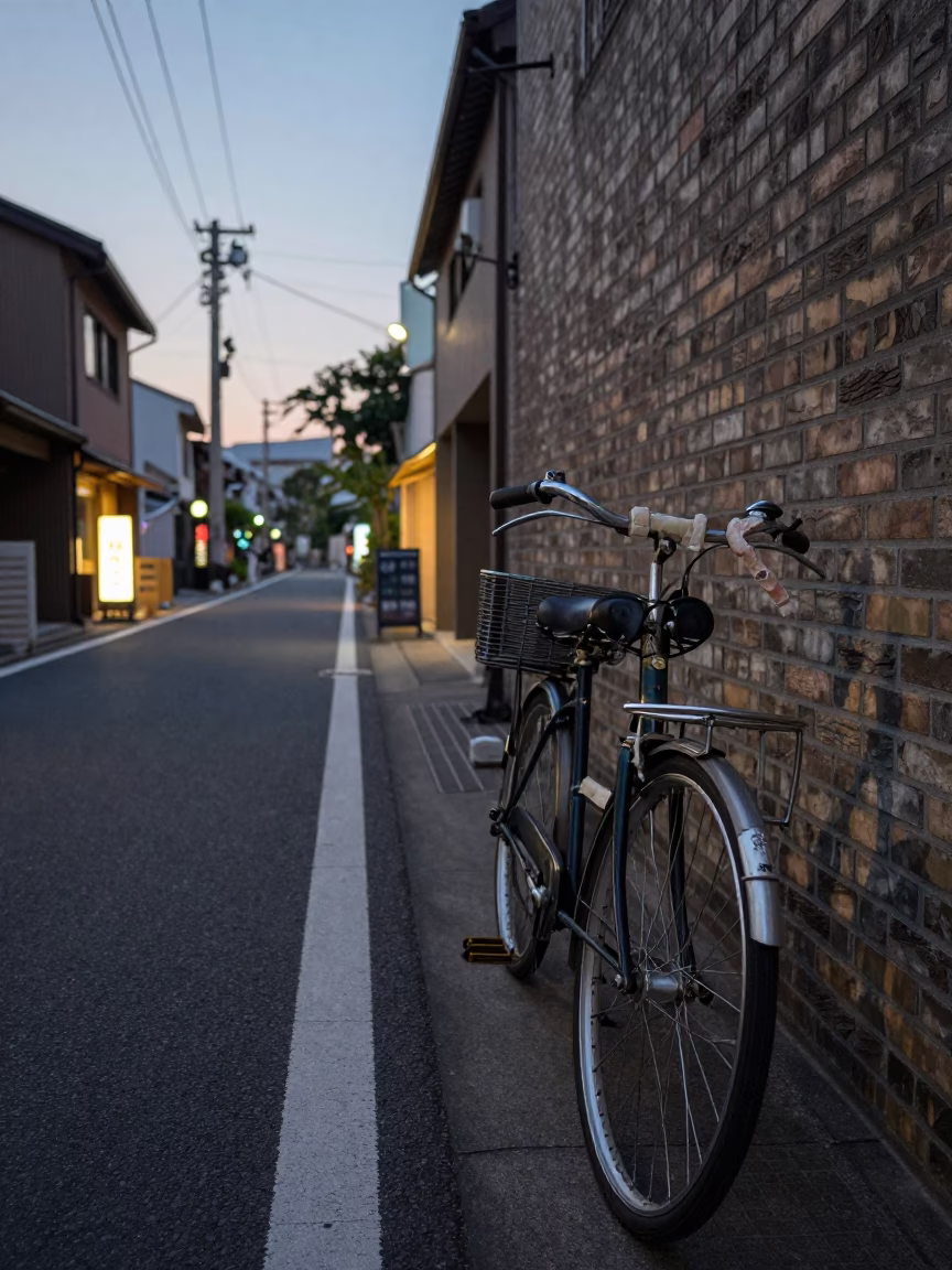 Pre-dawn Fukuoka street scene with vintage bicycle and glowing convenience store sign in in Fukuoka, Japan