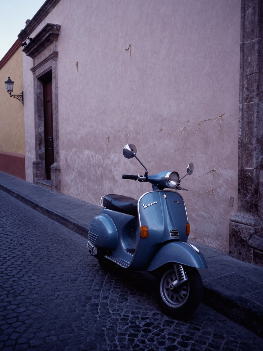 Pre-Dawn Guadalajara Street Scene with Vintage Vespa on Cobblestone Lane in in Guadalajara, Mexico