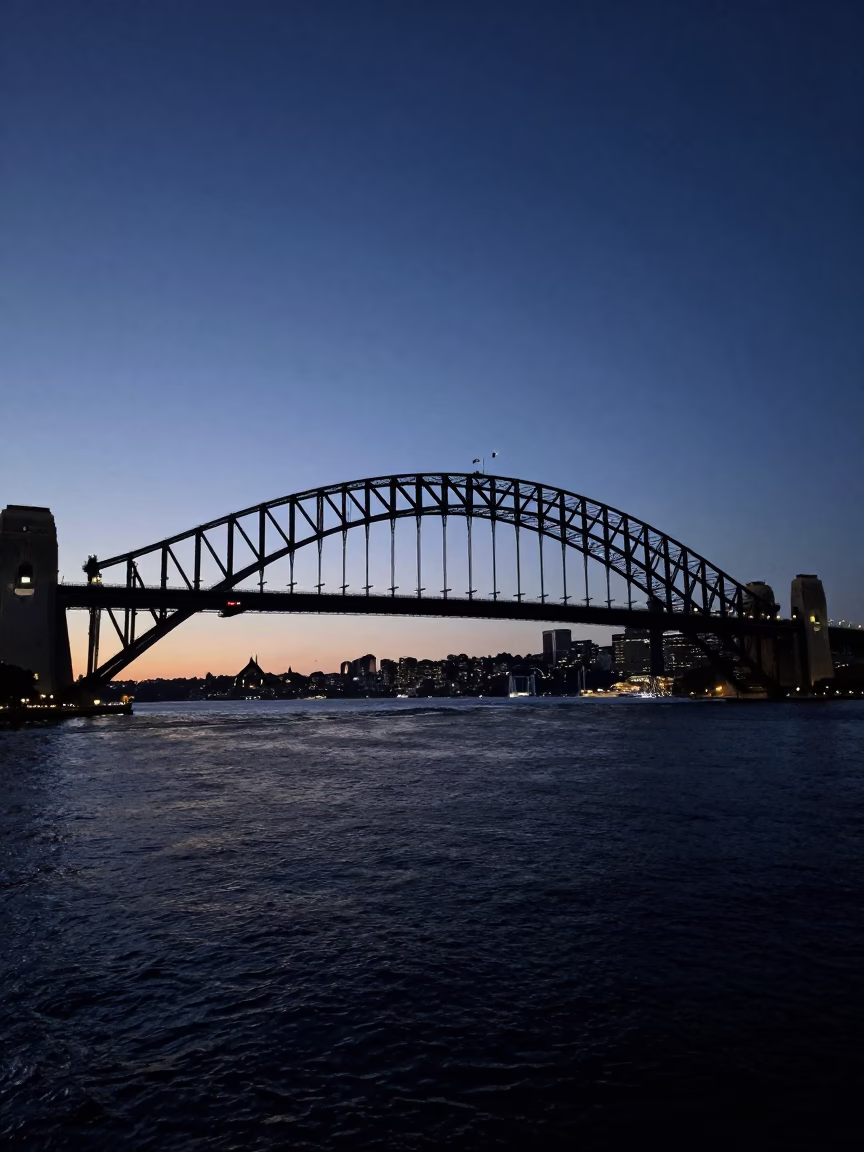 Pre-dawn Harbour Bridge Silhouette Over Dark Sydney Waters in in Sydney, New South Wales, Australia