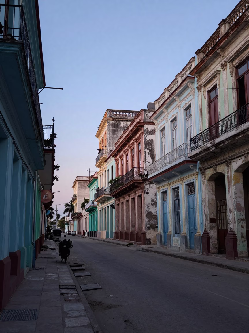 Pre-dawn Havana street scene with peeling colonial architecture and parked vehicles in Cuba in in Havana, Cuba