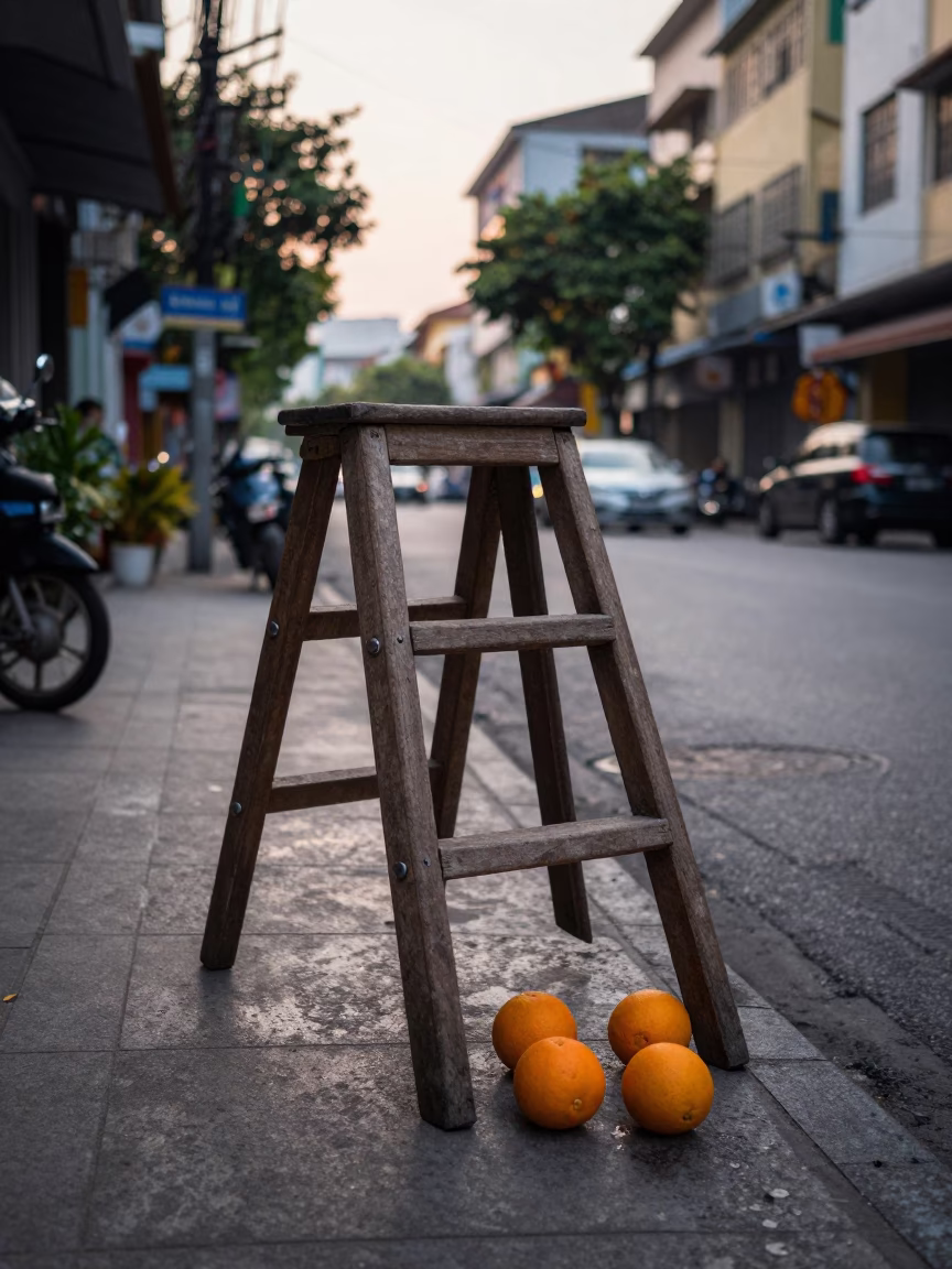 Pre-dawn Ho Chi Minh City Street Scene with Wooden Ladder and Oranges in in Ho Chi Minh City, Vietnam