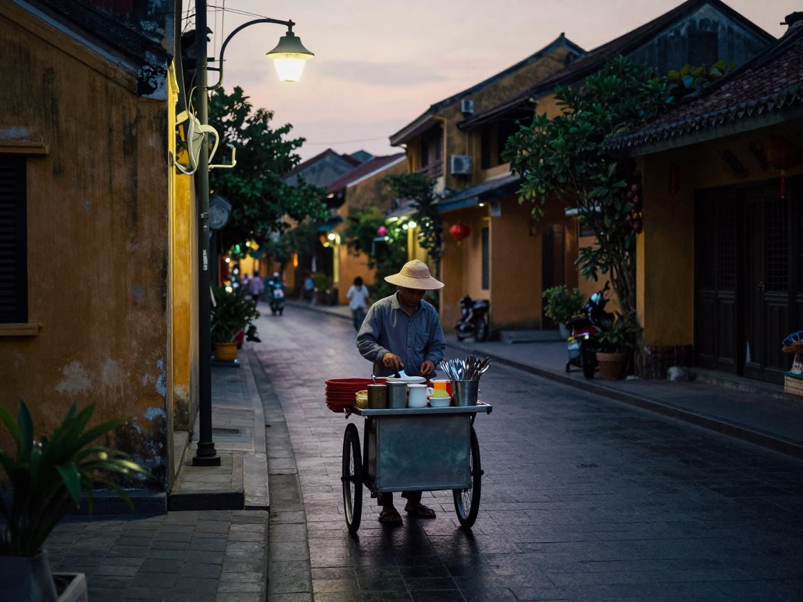 Pre-dawn Hoi An street vendor preparing coffee and cutlery before sunrise in in Hoi An, Vietnam
