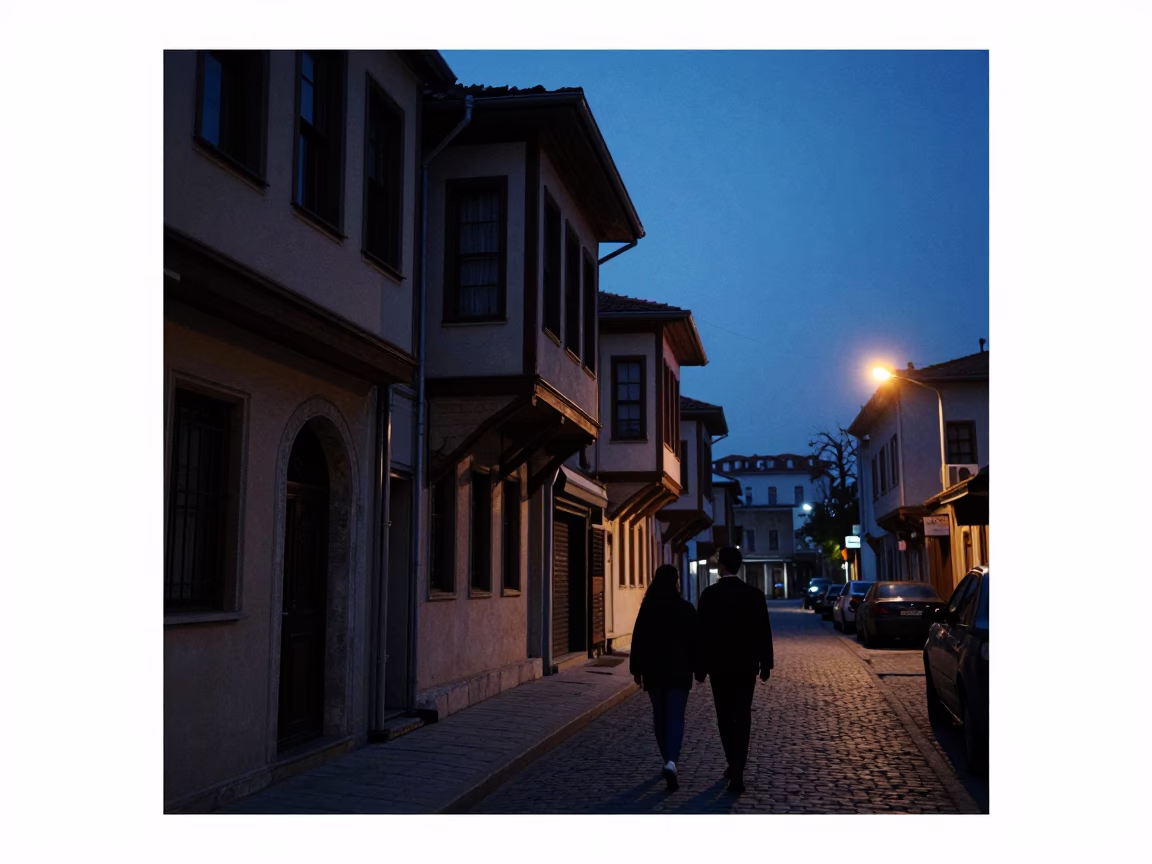 Pre-dawn Istanbul street scene with couple walking near traditional shop entrance in in Istanbul, Turkey