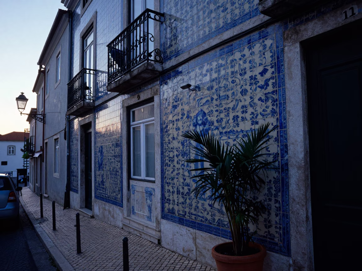 Pre-dawn Lisbon street scene with tiled facade and plant pot near historic building in in Lisbon, Portugal
