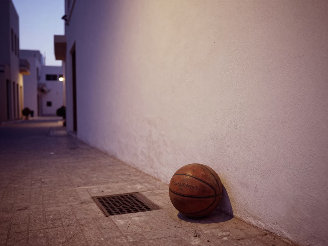 Pre-dawn Muscat Street Scene with Scratched Drain and Leather Basketball in Oman in in Muscat, Oman