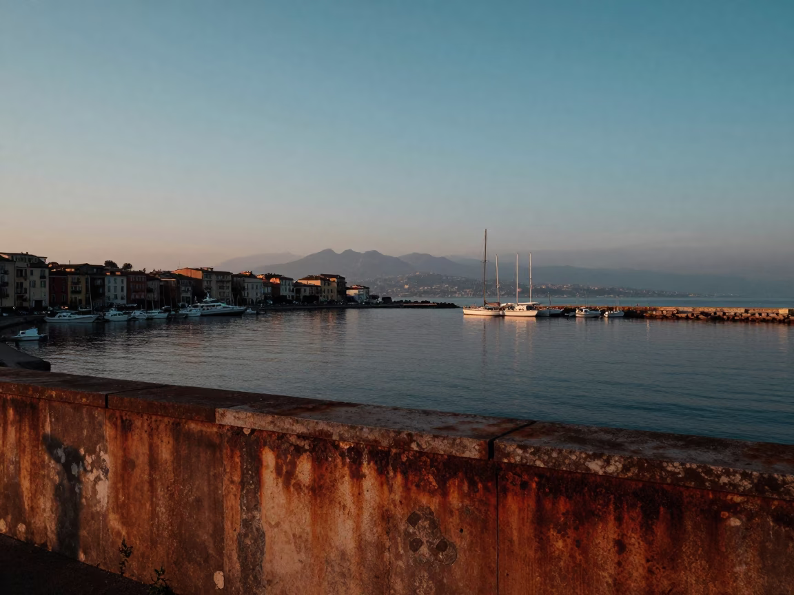 Pre-Dawn Naples Harbor View with Rusty Walls and Distant Bridge Illumination in in Naples, Italy