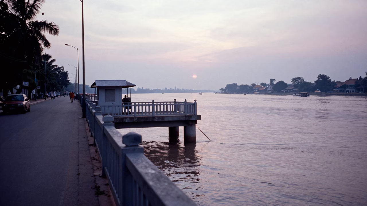 Pre-dawn Phnom Penh street scene with bridge pier and morning commuters in in Phnom Penh, Cambodia