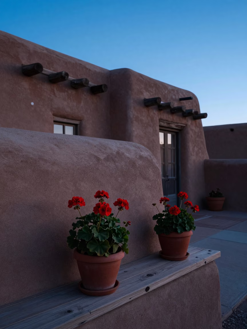 Pre-dawn Santa Fe adobe architecture and potted geraniums in cool morning light in in Santa Fe, New Mexico, United States