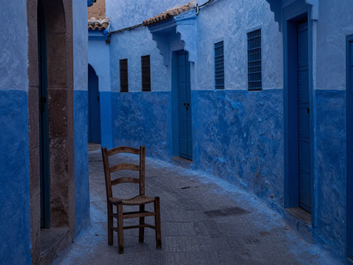 Pre-dawn street scene in Essaouira Morocco with worn wooden chair and drinking vessel in in Essaouira, Morocco