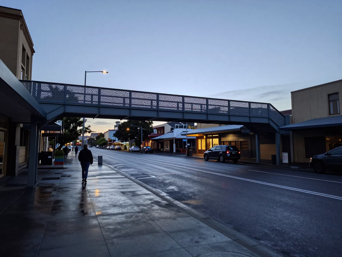 Pre-dawn street scene in Hobart Tasmania featuring wet pavement and pedestrian overpass in in Hobart, Tasmania, Australia