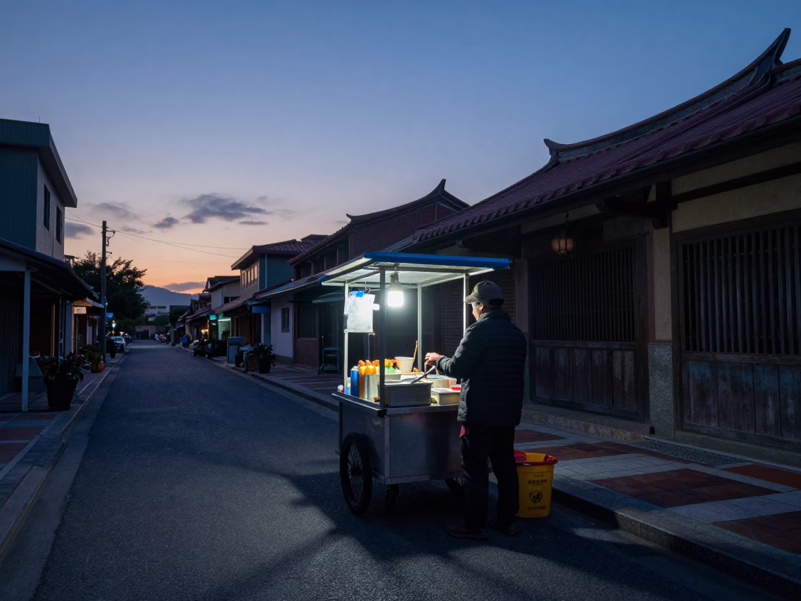 Pre-dawn street scene in Tainan Taiwan with food vendor and early morning light in in Tainan, Taiwan