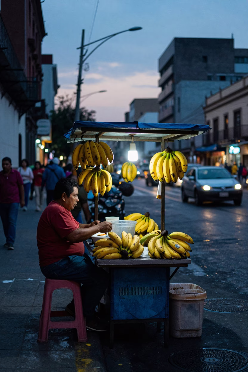 Pre-dawn street vendor stall in Mexico City with bananas and wet pavement reflections in in Mexico City, Mexico