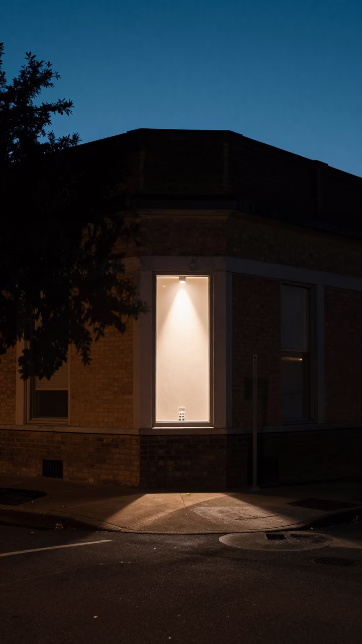 Predawn Austin Texas Street Corner with Glass Tumbler and Window Light on Drain in in Austin, Texas, United States