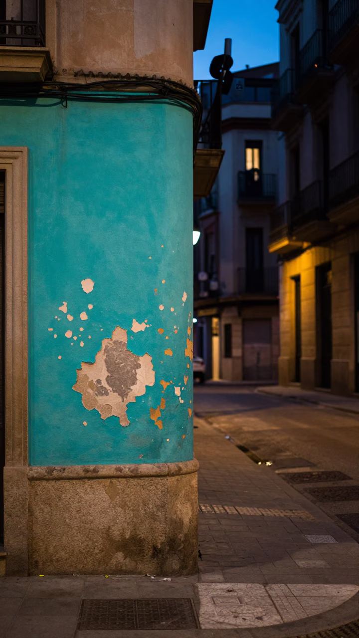 Predawn Barcelona Street Scene with Peeling Turquoise Paint and Quiet Urban Architecture in in Barcelona, Spain
