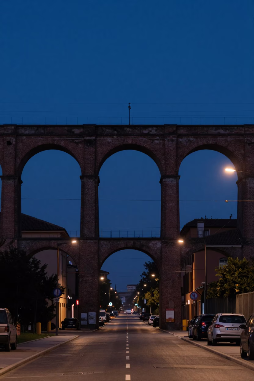 Predawn Bologna Italy Railway Viaduct Arching Over Quiet Streets with Passing Train in in Bologna, Italy