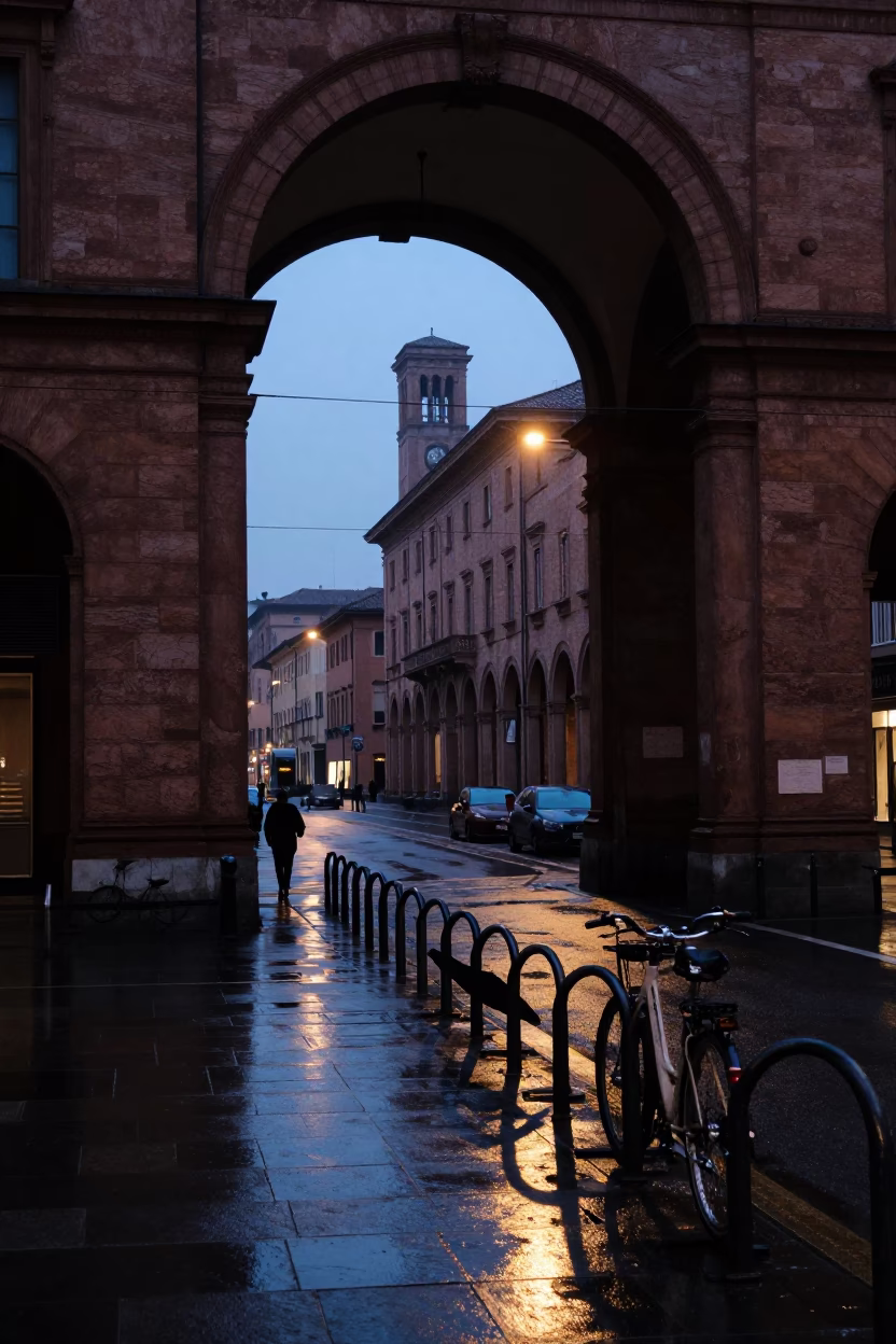 Predawn Bologna Italy Street Scene with University Archway and Wet Bicycle Rack in in Bologna, Italy